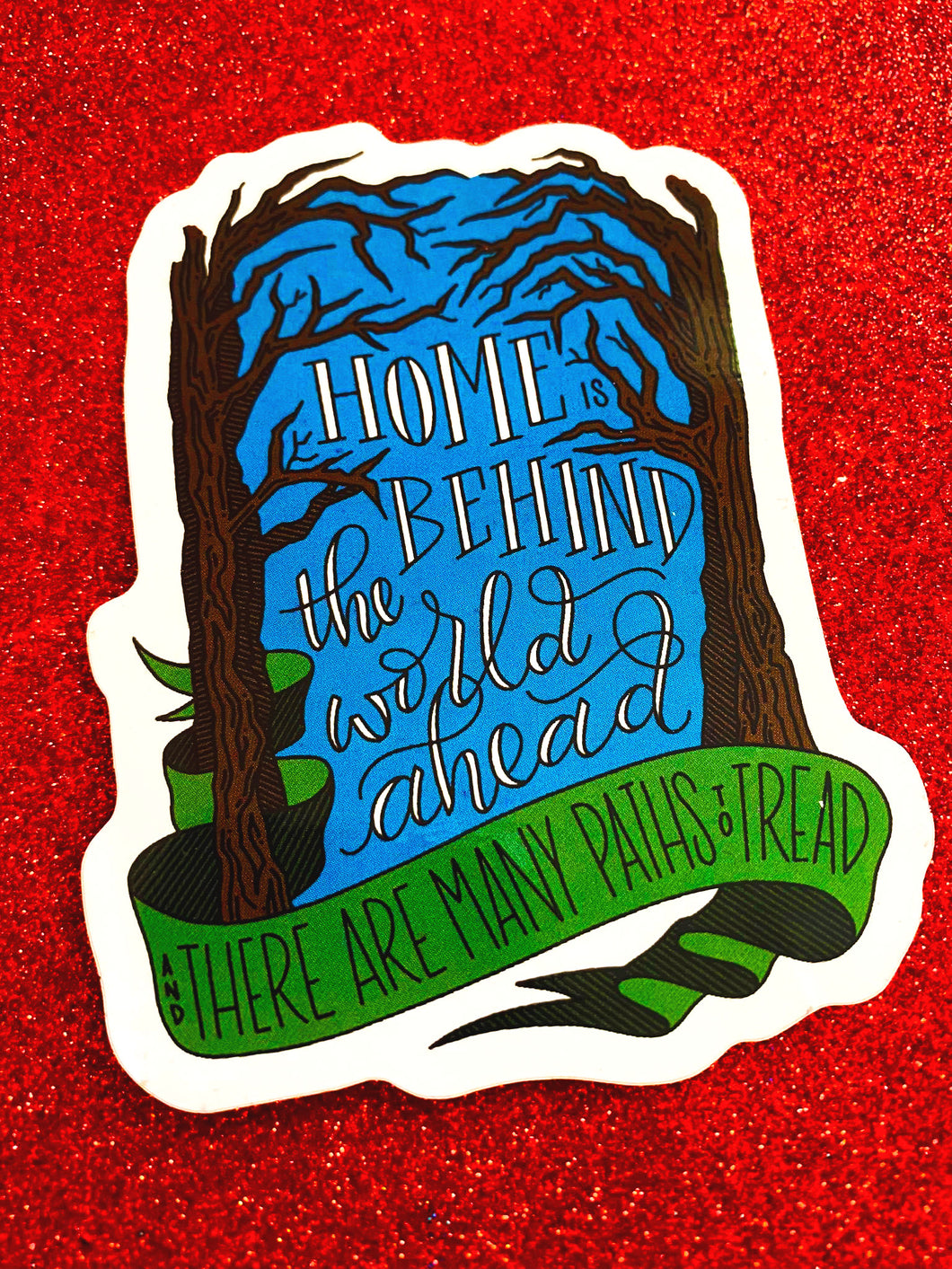Home is behind the world ahead and there are many paths to tread - Sticker quote